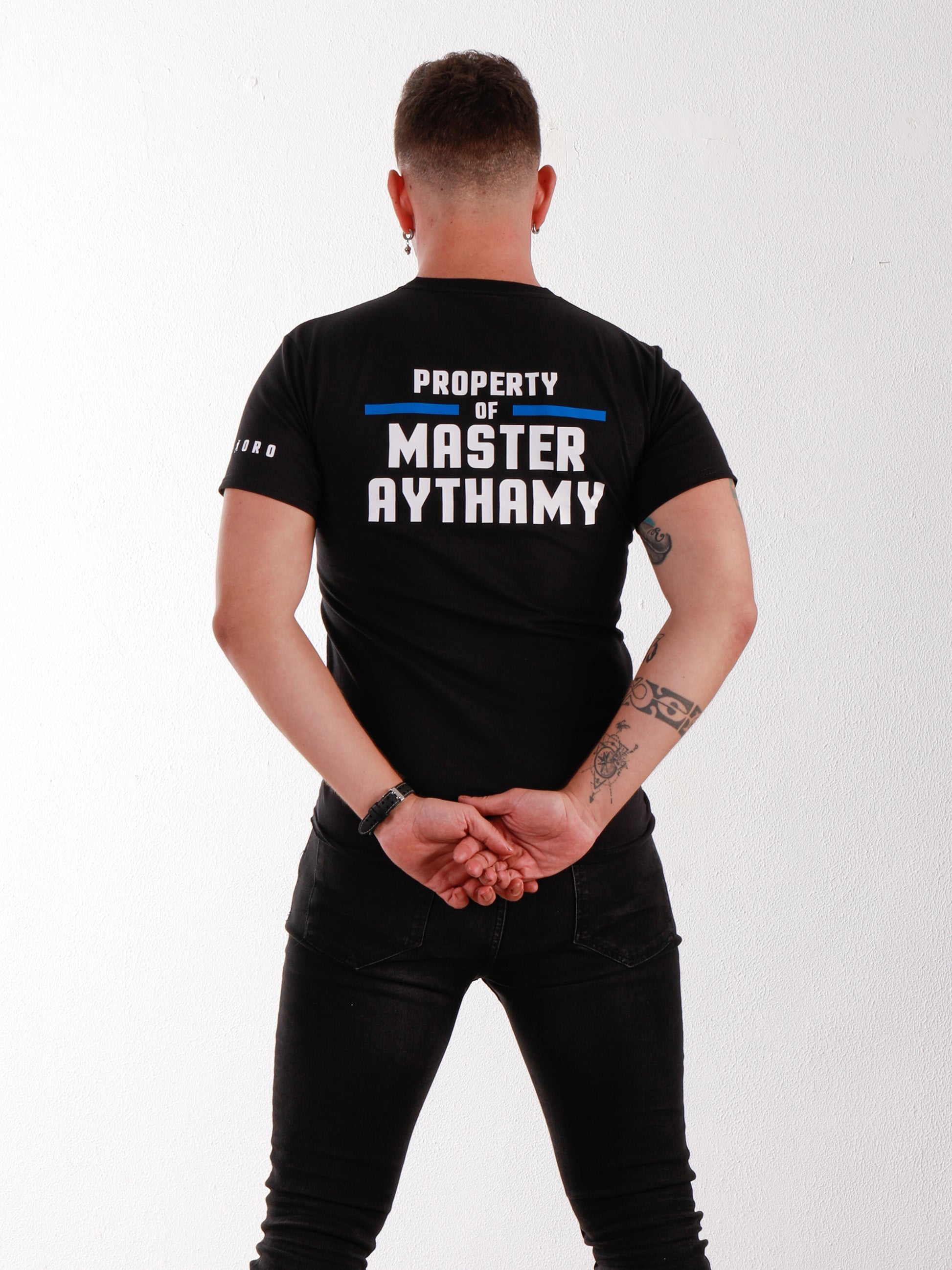 Designed for those who like control and connection. This double-sided black tee lets you personalize your “Property Of” statement while showing off the iconic Rabo De Toro padlock motif.
gay fetish fashion, custom shirt, property of design, padlock fetish tee, Rabo De Toro clothing, personalized BDSM shirt, fetish lifestyle wear