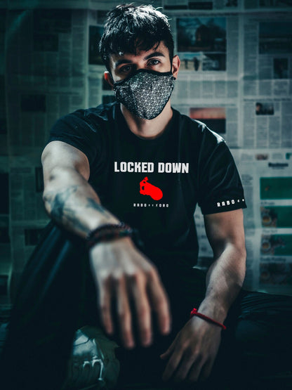 Male model wearing Rabo de Toro Locked Down black T-shirt inspired by gay chastity fetish fashion.