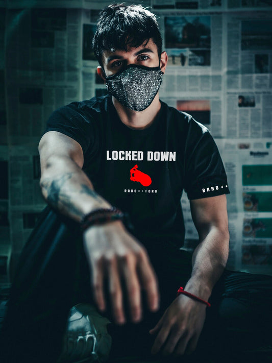 Male model wearing Rabo de Toro Locked Down black T-shirt inspired by gay chastity fetish fashion.