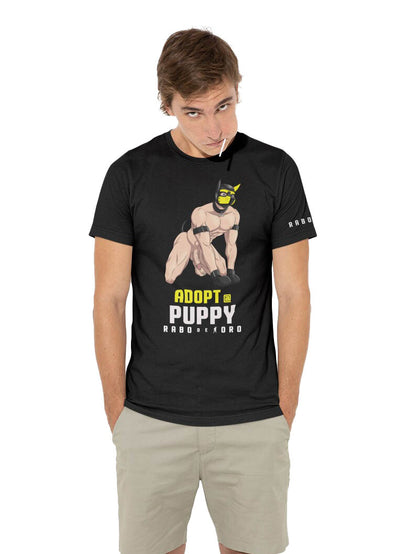 Designed for the pup community, this “Adopt a Puppy” tee connects identity, play, and pride. Soft cotton comfort with a kinky message for events or casual wear.
 pup play t-shirt, gay fetish gear, bdsm fashion, Rabo De Toro tee, puppy community, fetish apparel